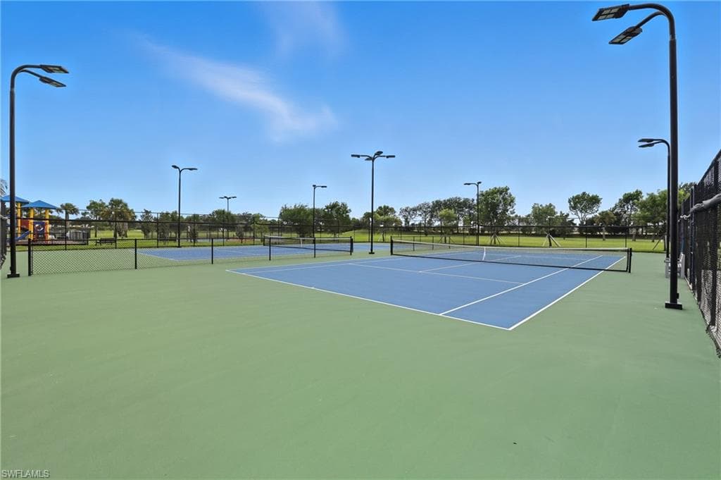 View of tennis court with community basketball court