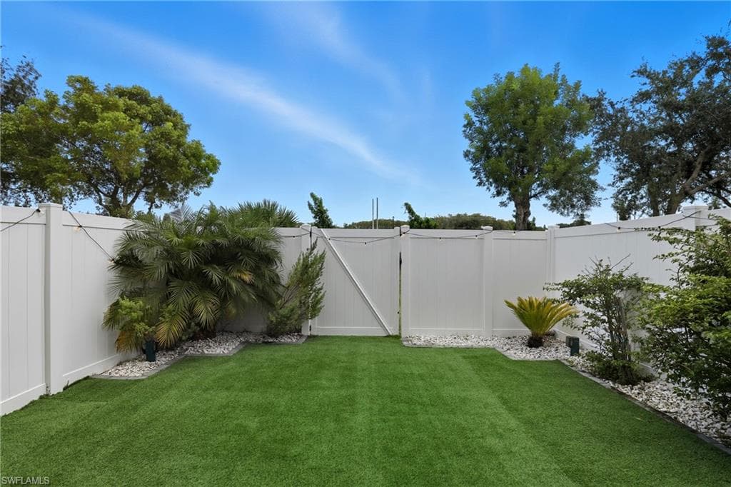 Fenced backyard with a gate