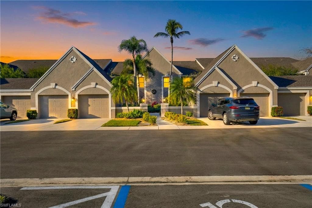 Ranch-style home featuring stucco siding