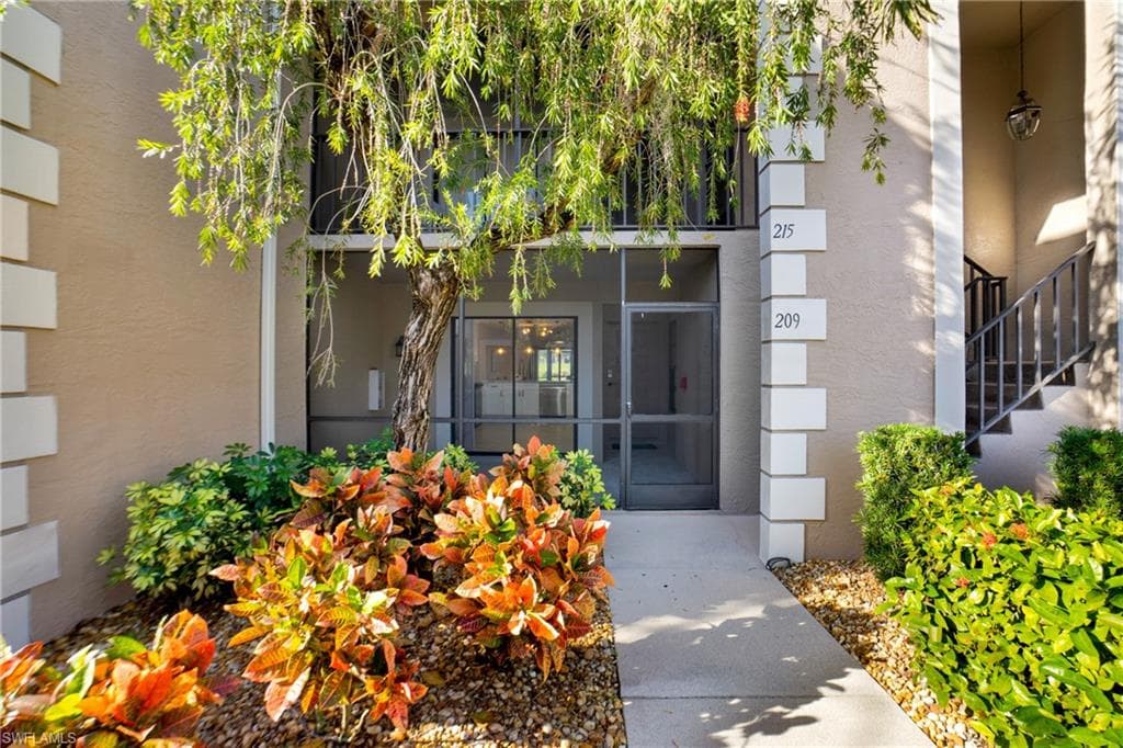 View of exterior entry featuring stucco siding