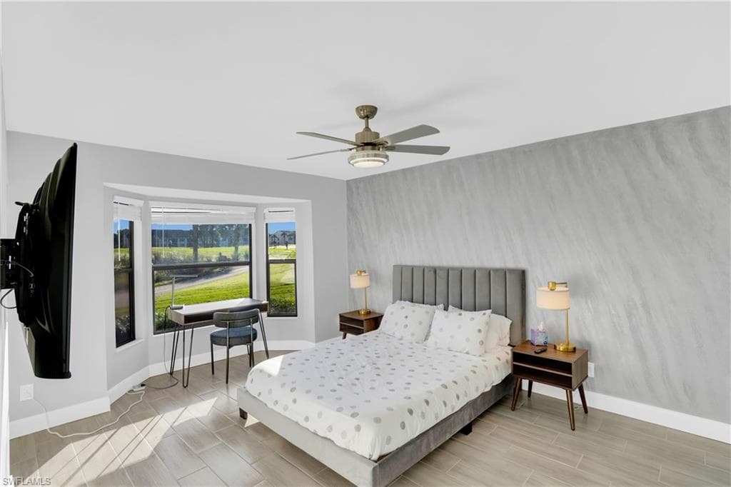Bedroom featuring wood tiled floors and ceiling fan