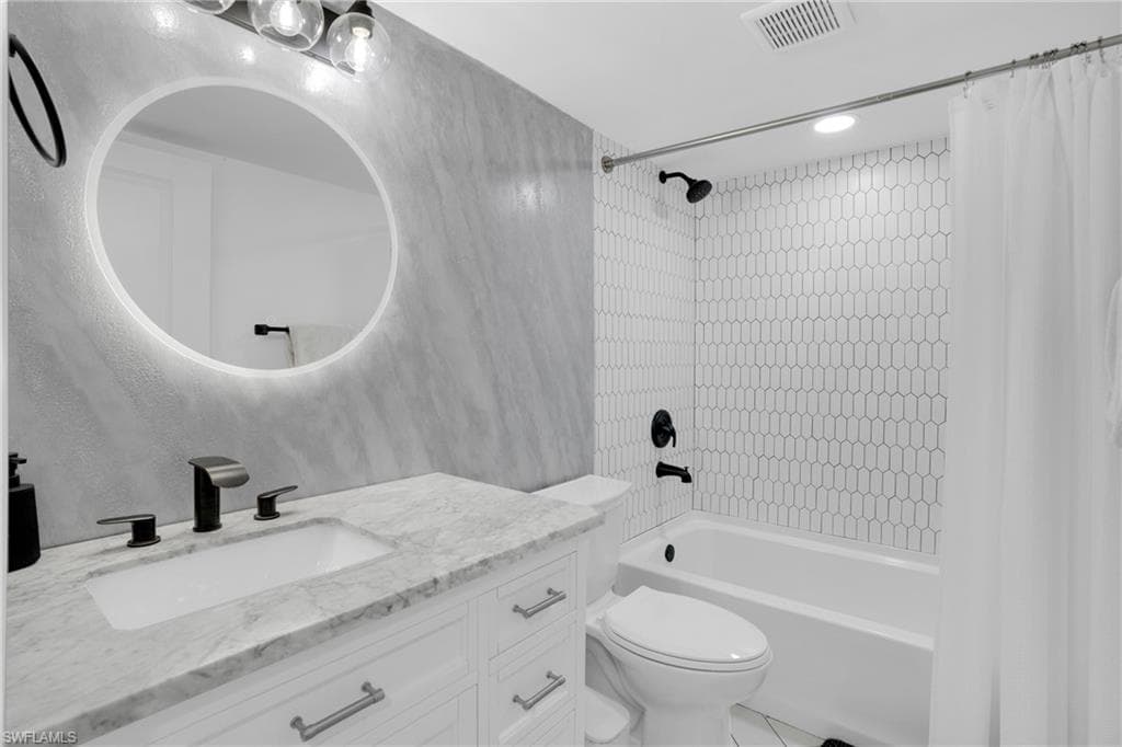 Full bath with shower / bathtub combination with curtain, vanity, and recessed lighting