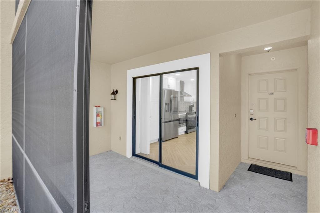 Property entrance featuring stucco siding