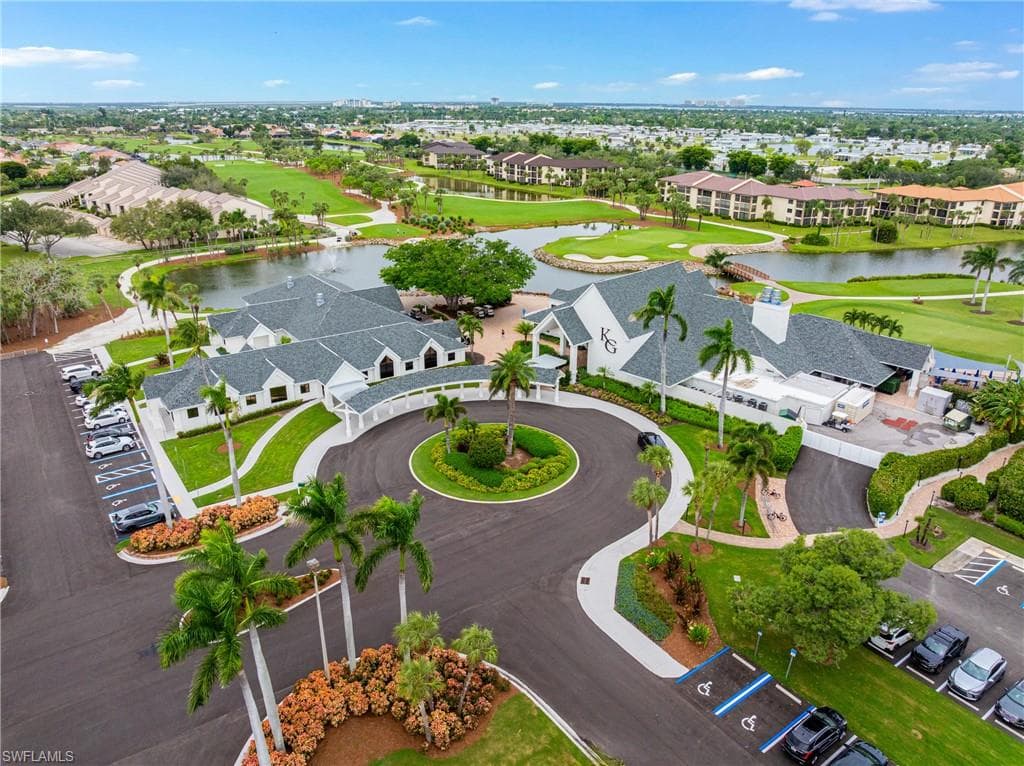 Aerial view of residential area with a golf course and a large body of water