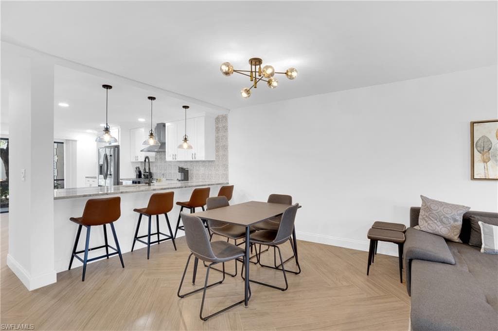 Dining space with a chandelier and baseboards