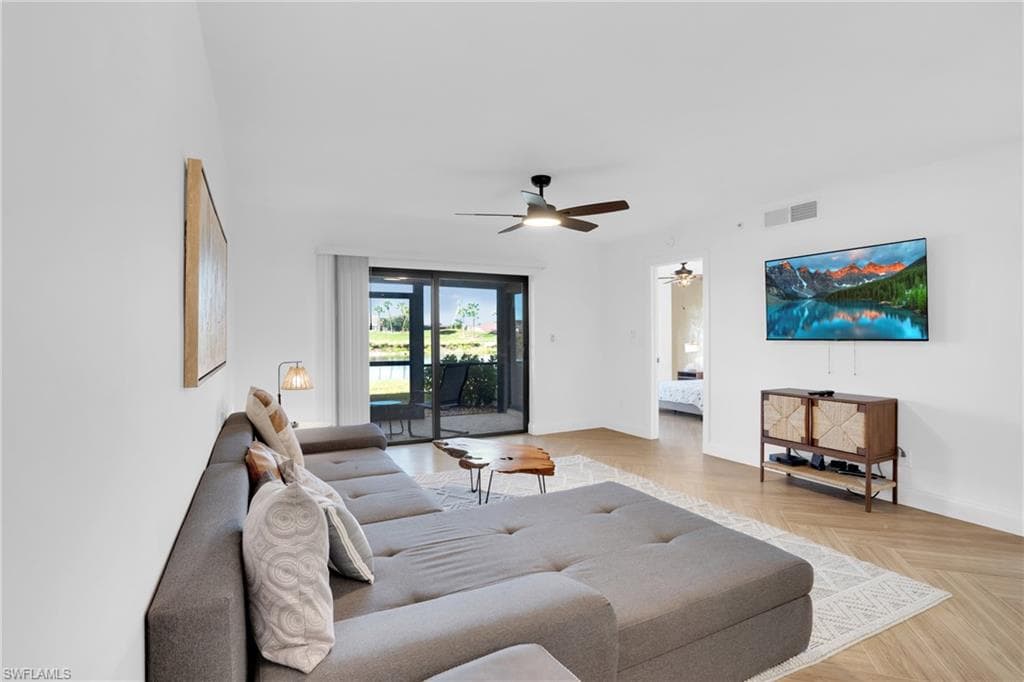 Living room featuring baseboards and a ceiling fan