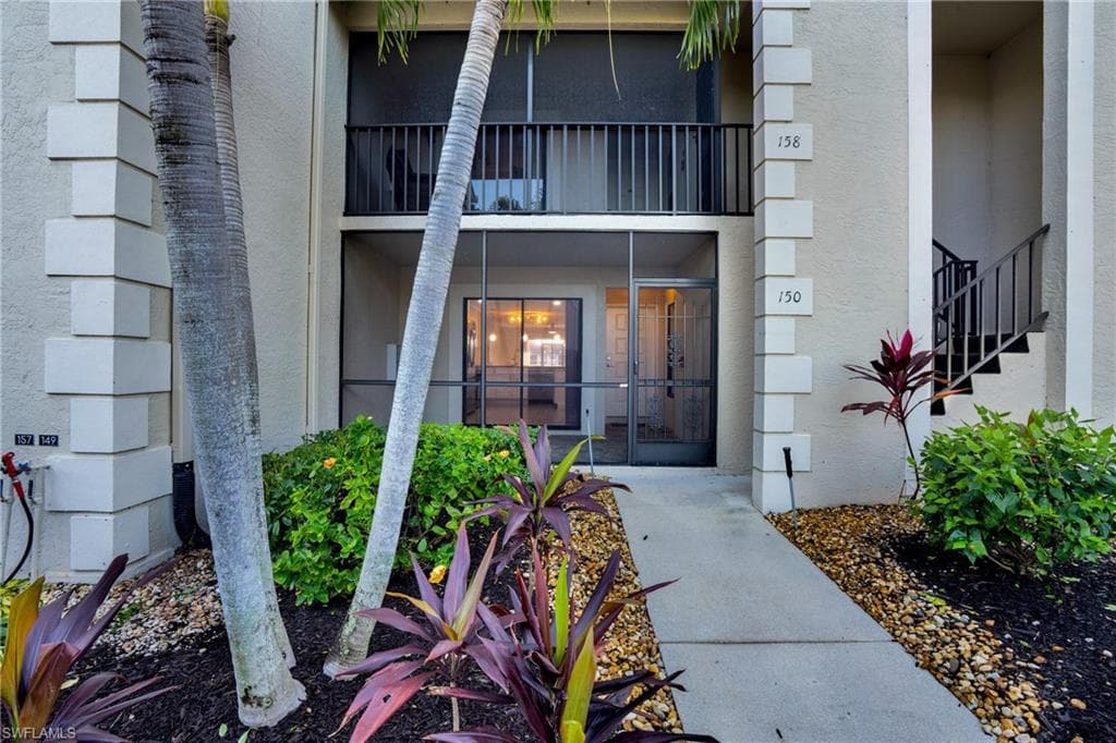 Entrance to property with stucco siding