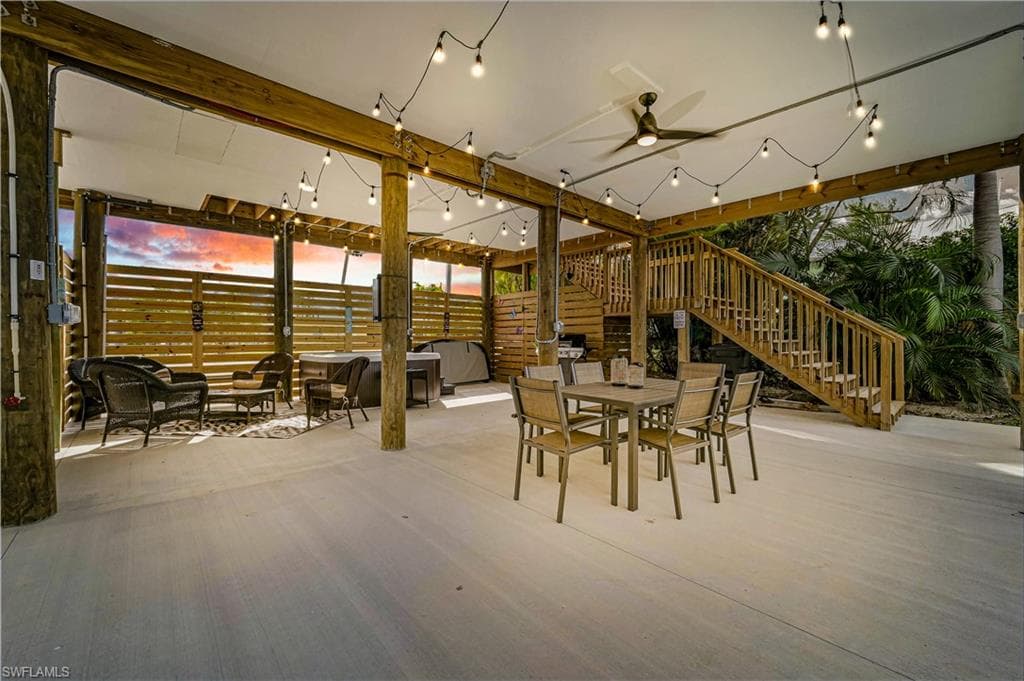 View of patio with stairs, a ceiling fan, and outdoor dining area