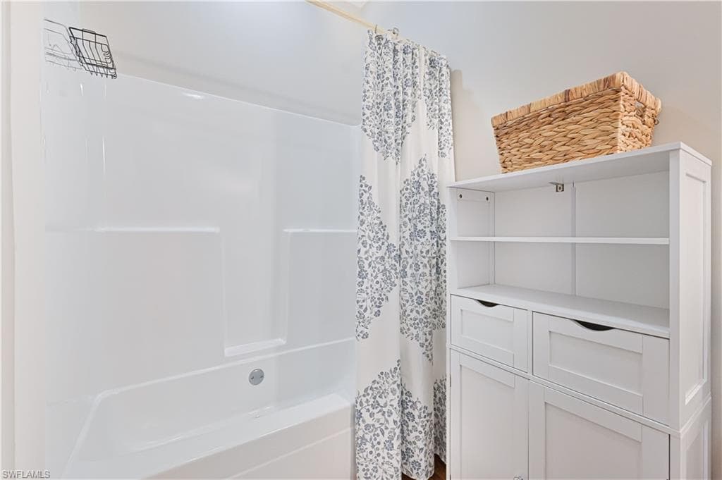 Bathroom featuring shower / bath combo with shower curtain
