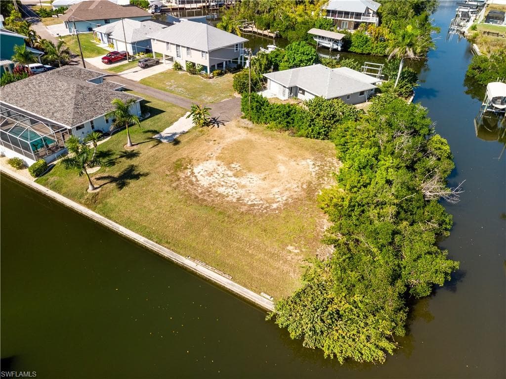 Aerial view of residential area featuring a nearby body of water
