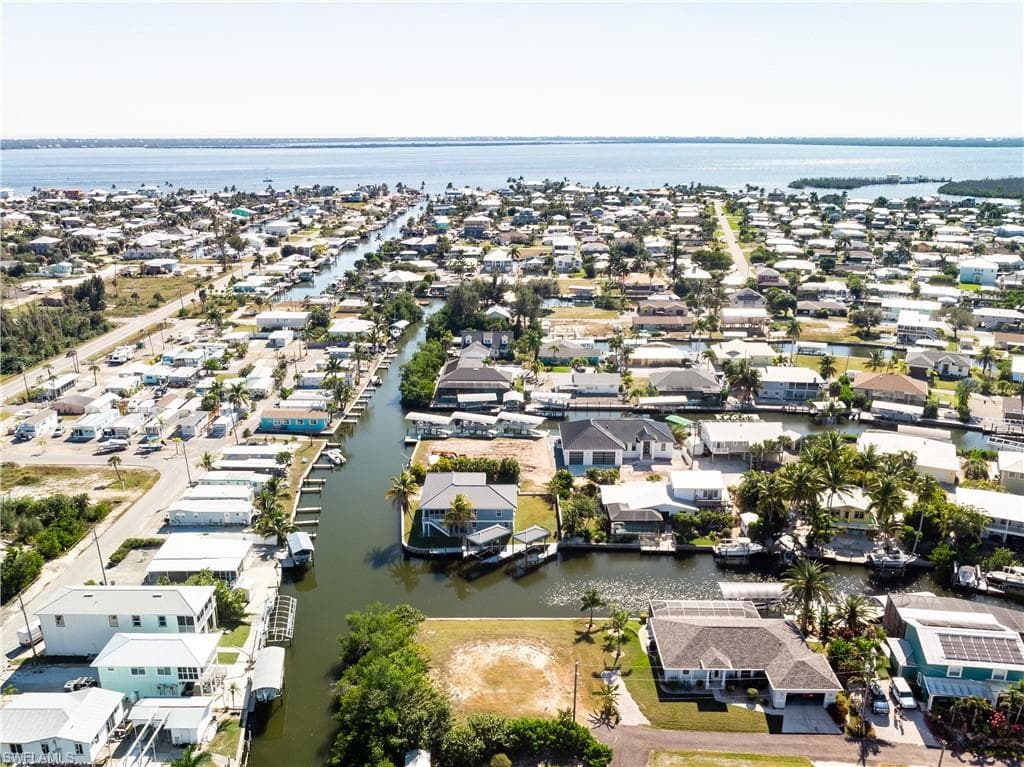 Aerial view of residential area featuring a nearby body of water