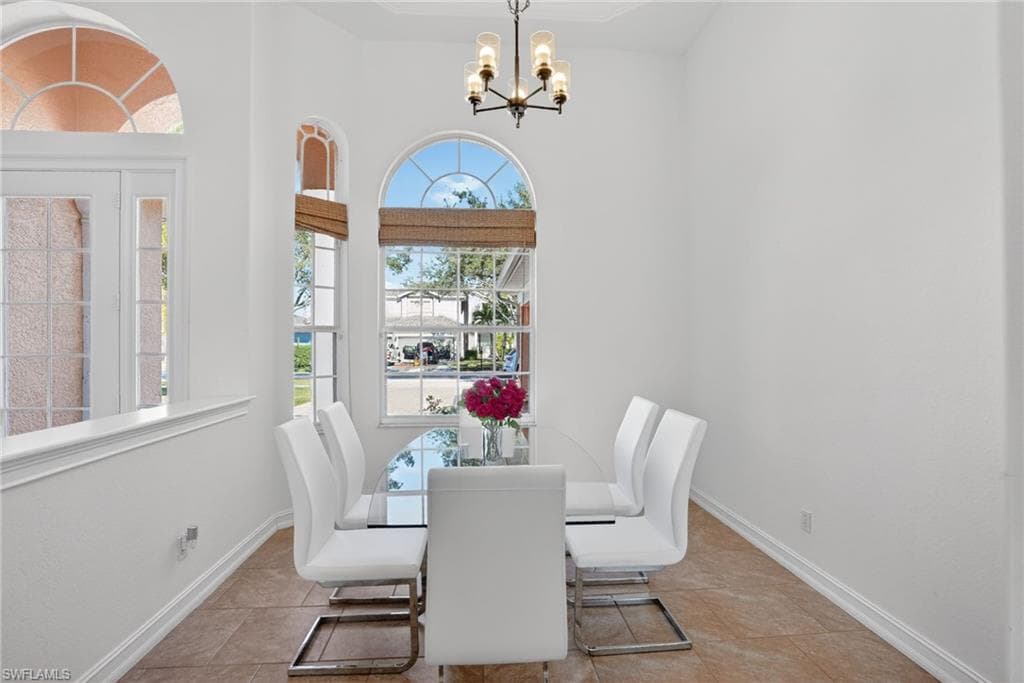 Dining space featuring a chandelier and tile patterned flooring