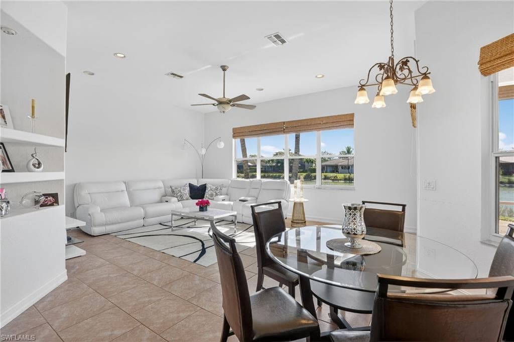 Dining area featuring a ceiling fan, light tile patterned flooring, a chandelier, and recessed lighting