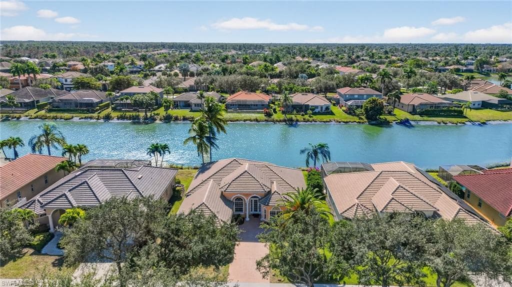 Aerial view of residential area featuring a large body of water