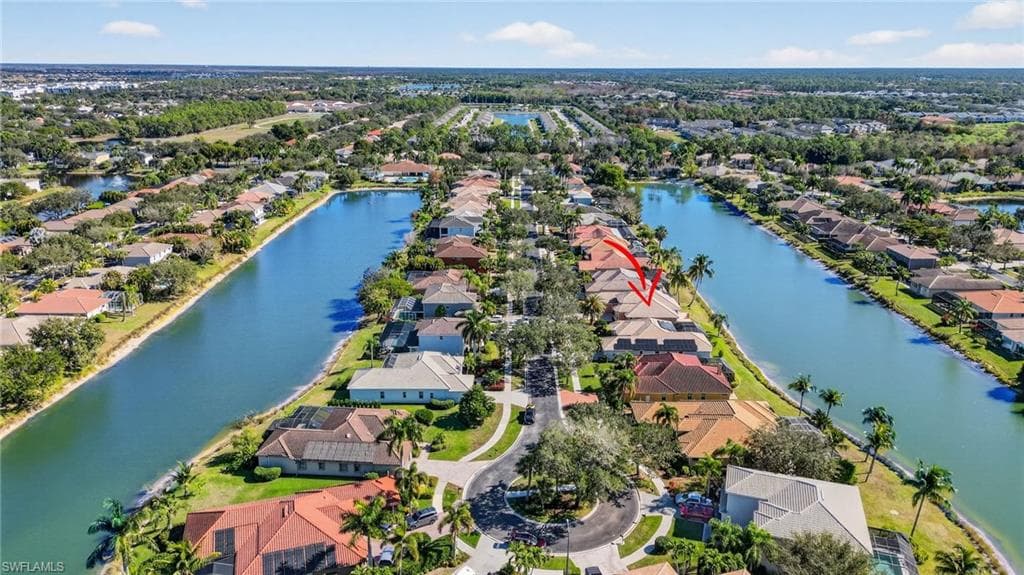 Aerial perspective of suburban area with a nearby body of water