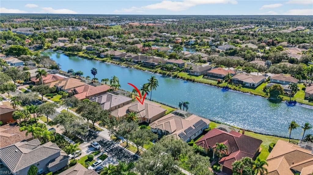 Aerial perspective of suburban area featuring a nearby body of water