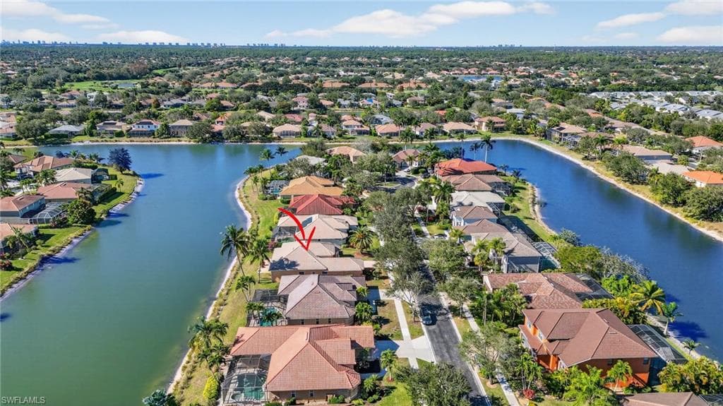 Aerial view of residential area featuring a large body of water
