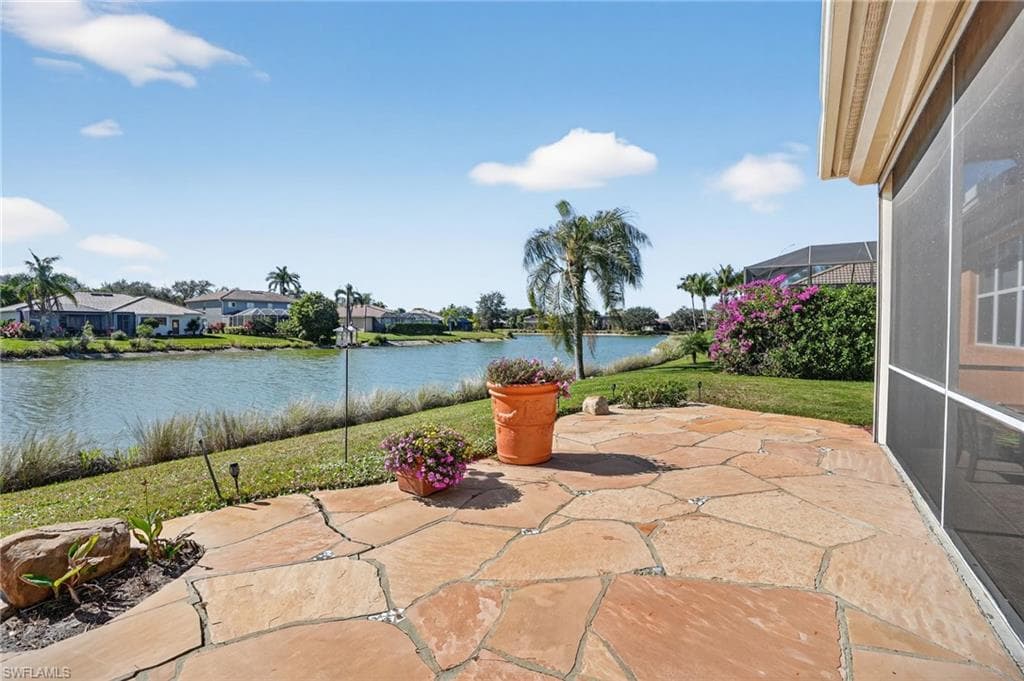 View of patio / terrace with a water view, a sunroom, a residential view, and a lanai