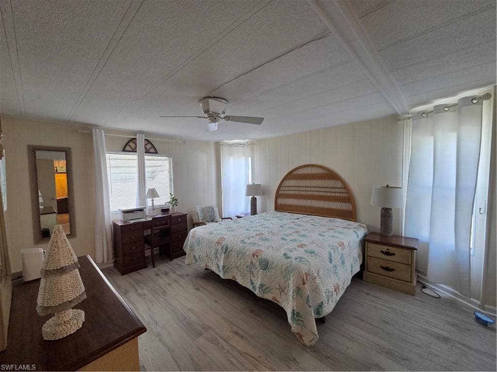 Ceiling fan and new flooring in the spacious Primary Bedroom