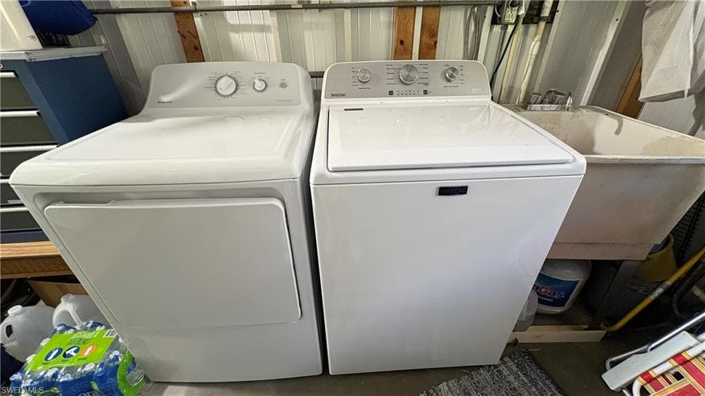 New washer and dryer are conveniently located in the storage shed with the laundry tub.