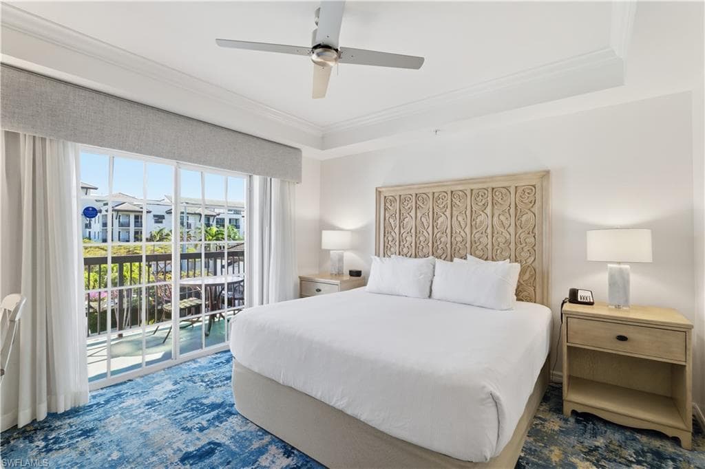 Bedroom featuring crown molding, access to outside, ceiling fan, and a tray ceiling