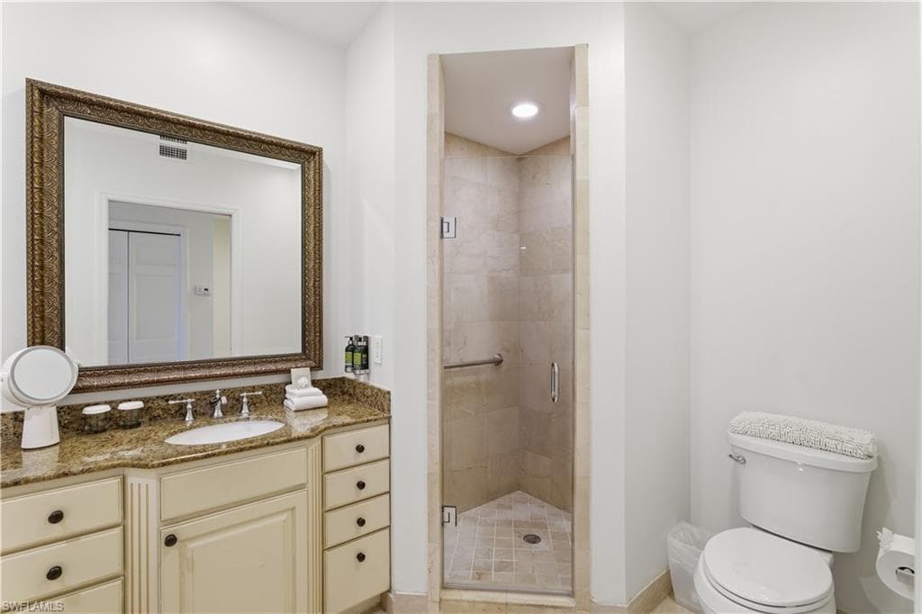 Full bath with a shower stall and vanity