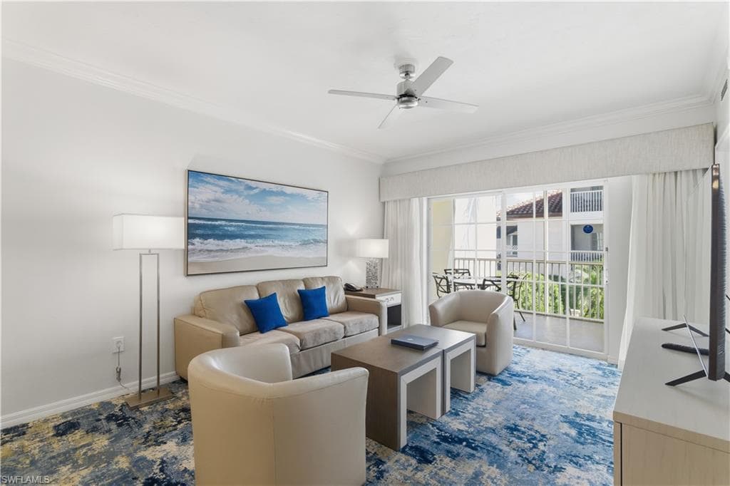 Living area featuring crown molding and ceiling fan