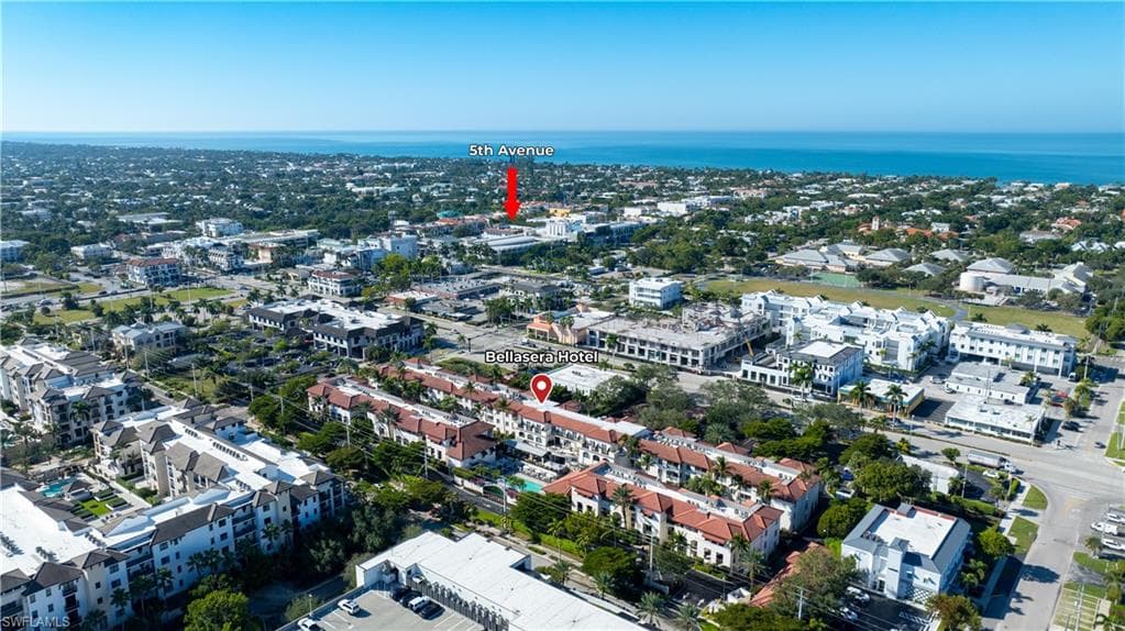 Aerial view of property's location with nearby urban area and a nearby body of water