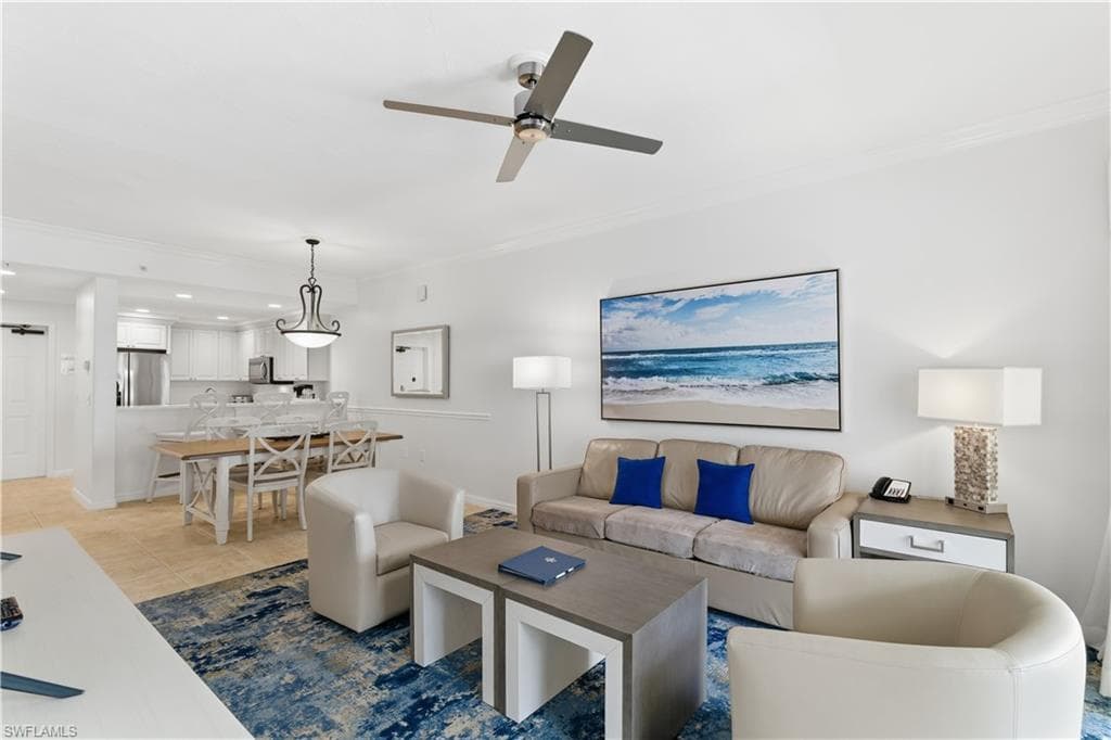 Living area featuring ornamental molding, recessed lighting, a ceiling fan, and light tile patterned floors