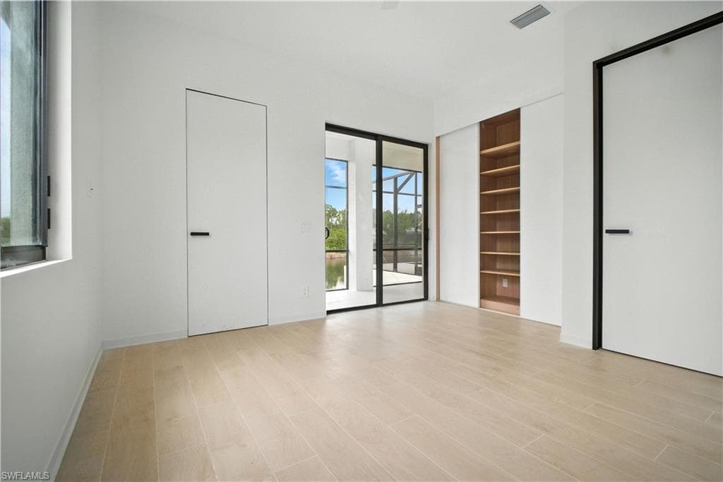 Unfurnished bedroom featuring access to outside and light wood finished floors