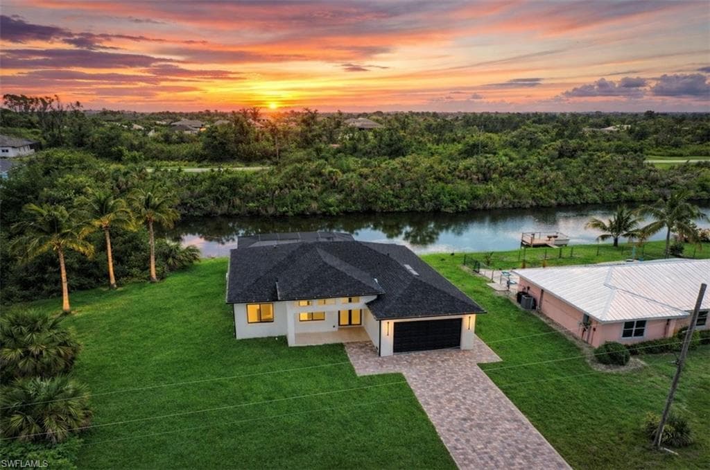 Aerial view at dusk of a water view and view of scattered trees (Rendered photo)