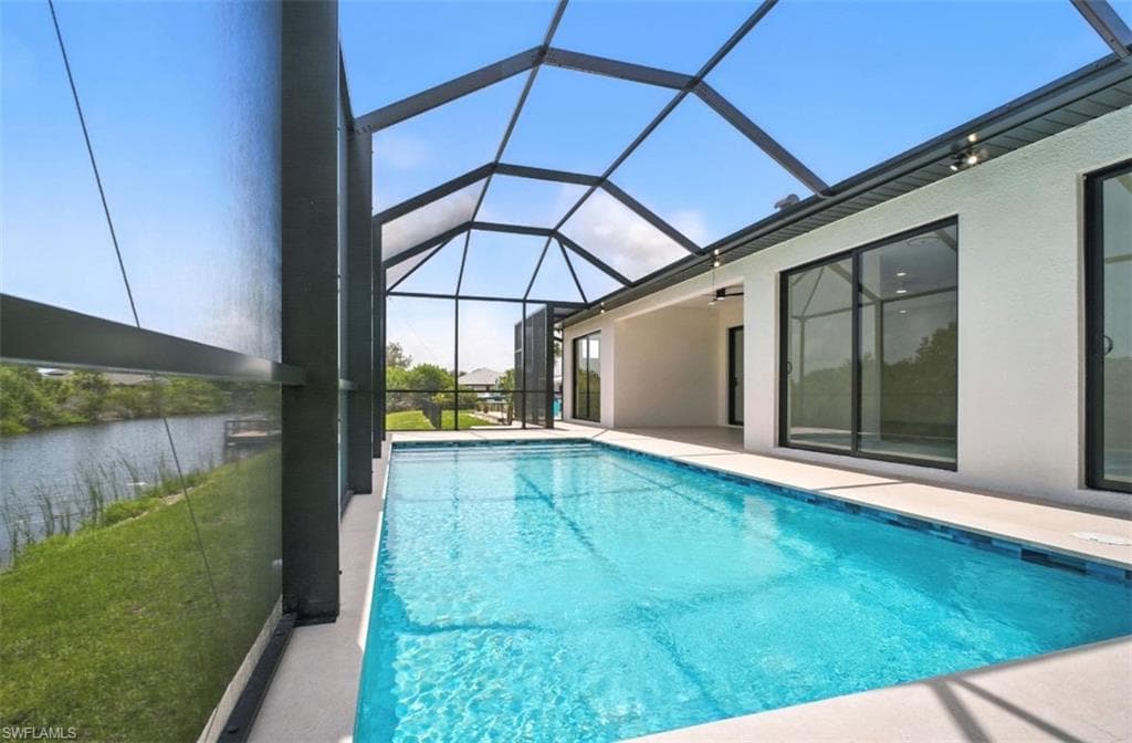 Swimming pool featuring a sunroom, a lanai, and a patio area