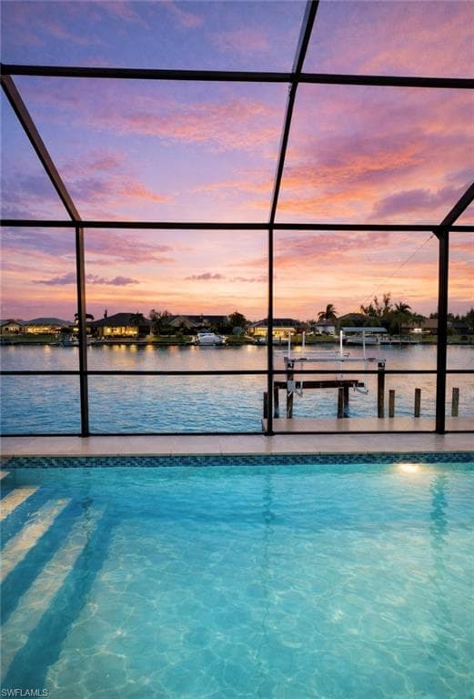 Outdoor pool with boat lift, a dock, a lanai, and a sunroom (Rendered photo)