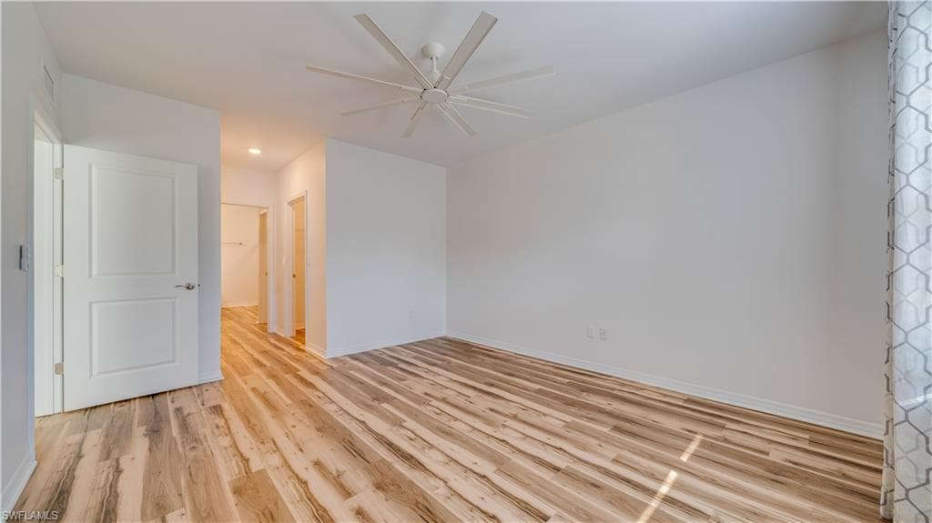 Unfurnished room featuring light wood-style flooring, ceiling fan, and recessed lighting