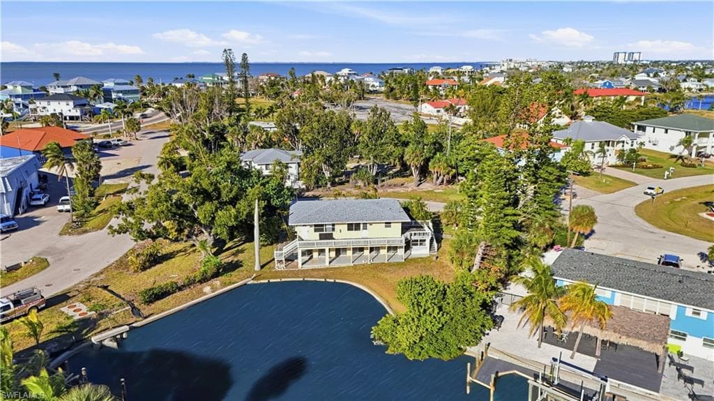 Aerial view of residential area featuring a nearby body of water - Virtually Edited Image