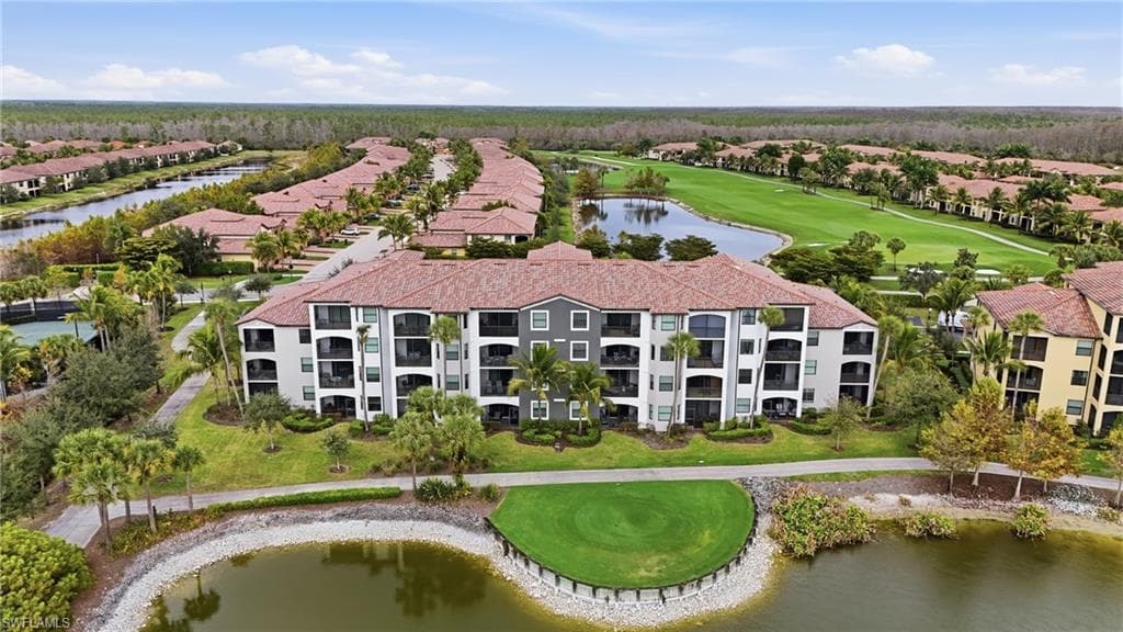 Aerial view of residential area with a nearby body of water and a golf club