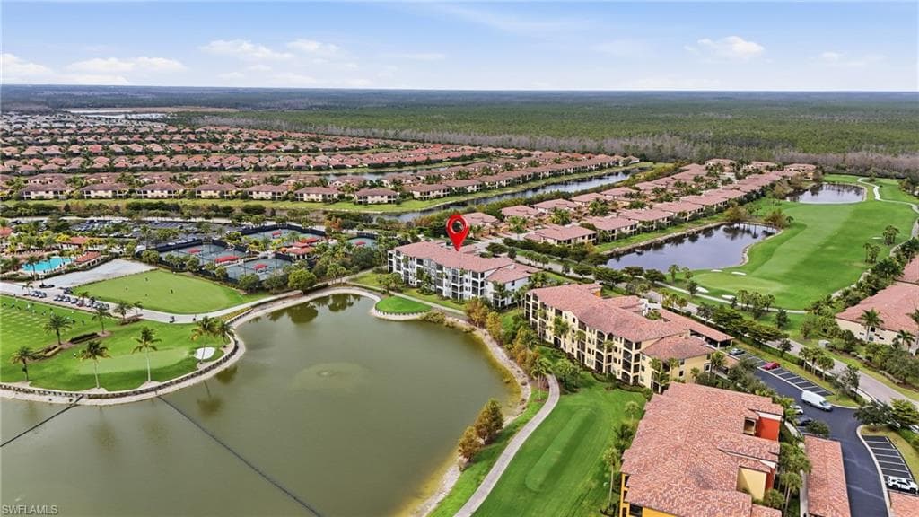 Aerial view of property's location featuring a golf club, a nearby body of water, and nearby suburban area