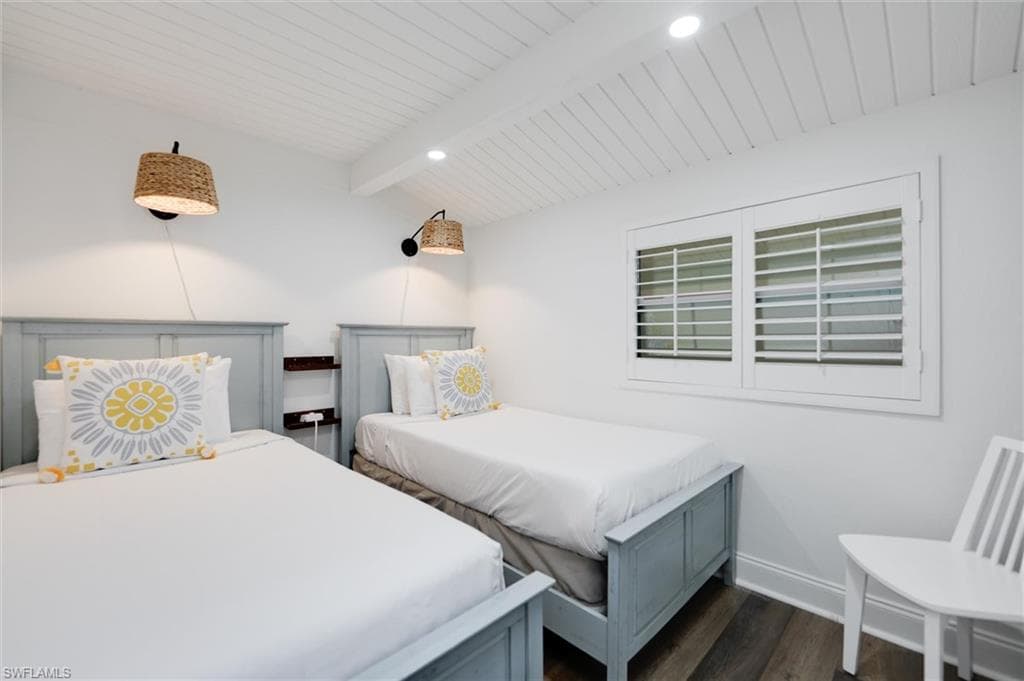 Bedroom with dark wood finished floors and wooden ceiling