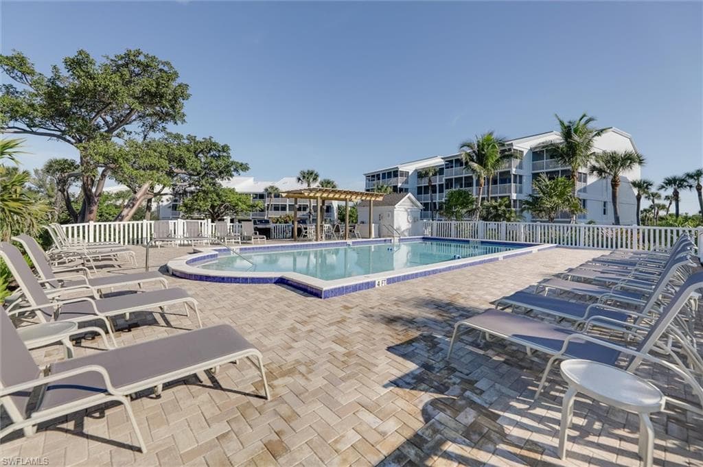 Community pool featuring a patio and a pergola