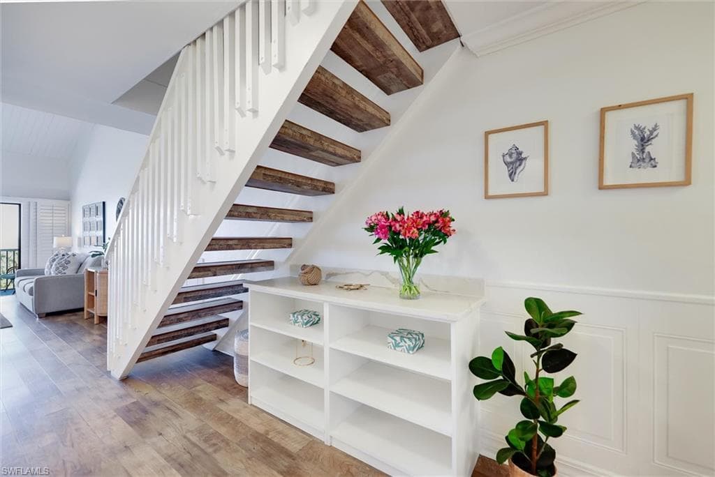 Stairs featuring wood finished floors