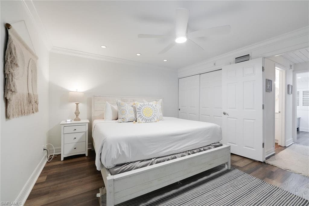 Bedroom with ornamental molding, ceiling fan, a closet, dark wood-type flooring, and recessed lighting