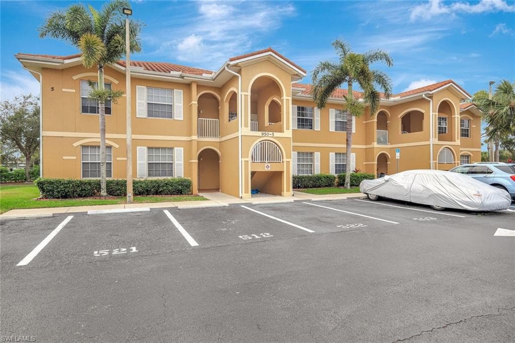 View of property featuring uncovered parking