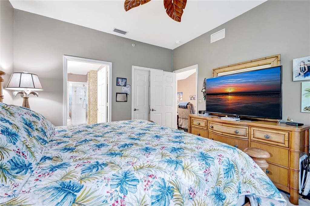 Bedroom with ceiling fan and ensuite bath
