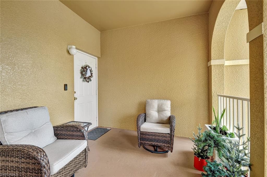 Doorway to property featuring stucco siding