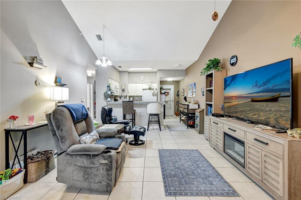 Living area featuring a chandelier and light tile patterned floors