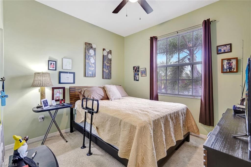 Bedroom with ceiling fan and carpet floors
