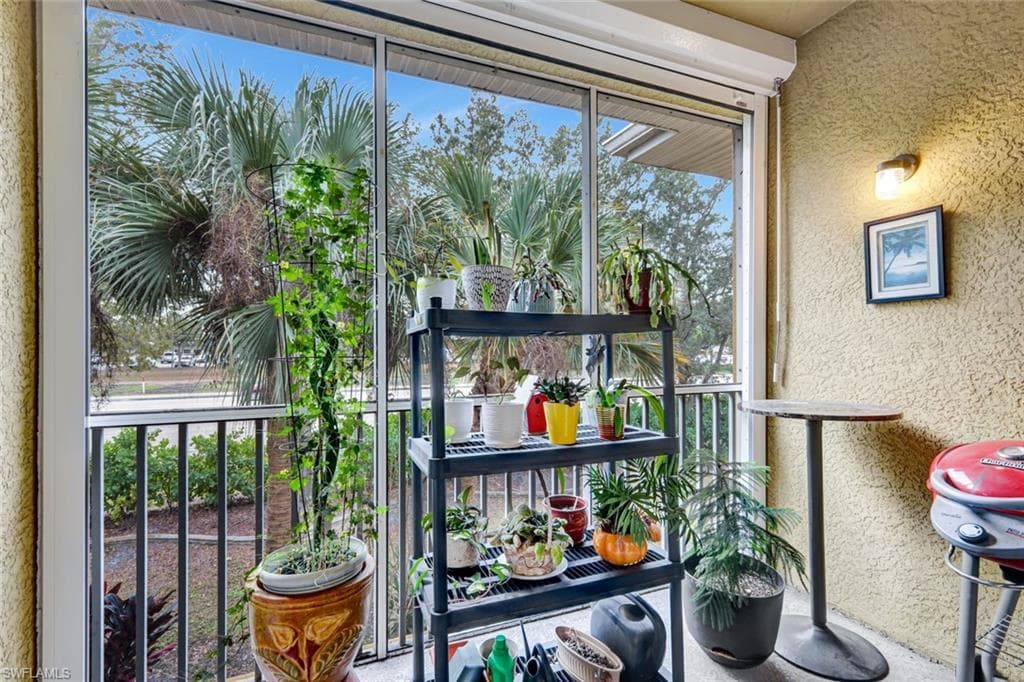 Balcony with a sunroom and area for grilling