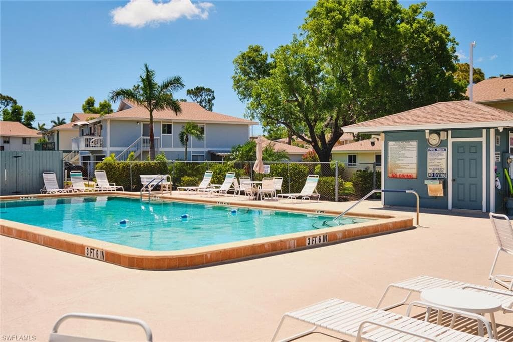 Community pool with a patio