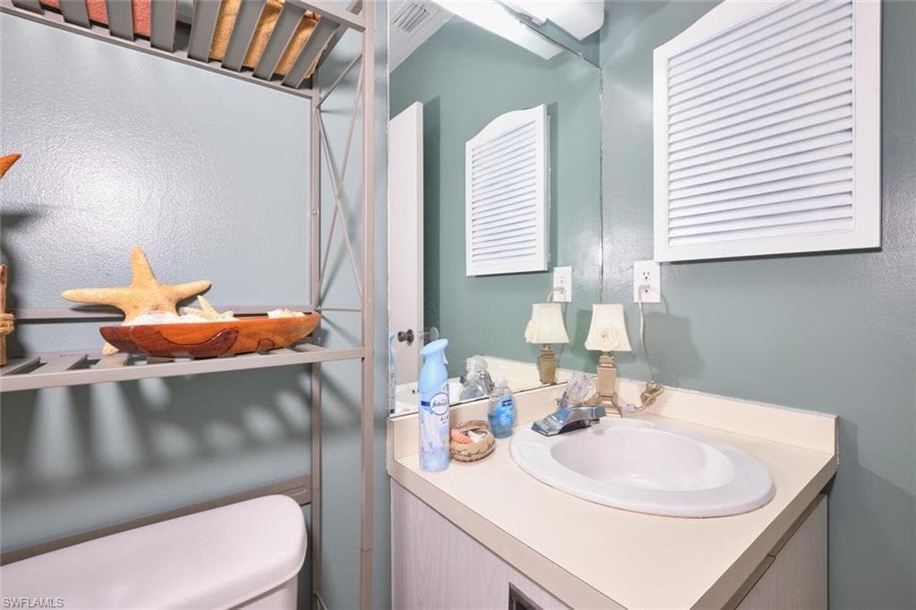Half bath with vanity and toilet