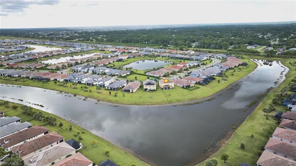 Aerial view of property's location with nearby suburban area and a large body of water